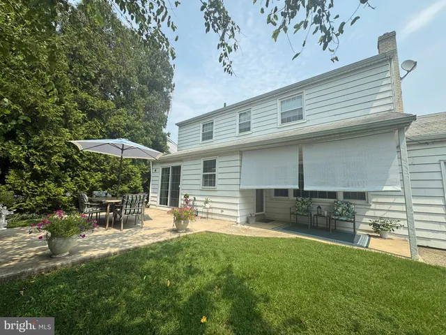 a view of a chairs and table under an umbrella