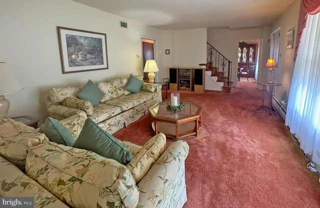 a living room with furniture and a rug