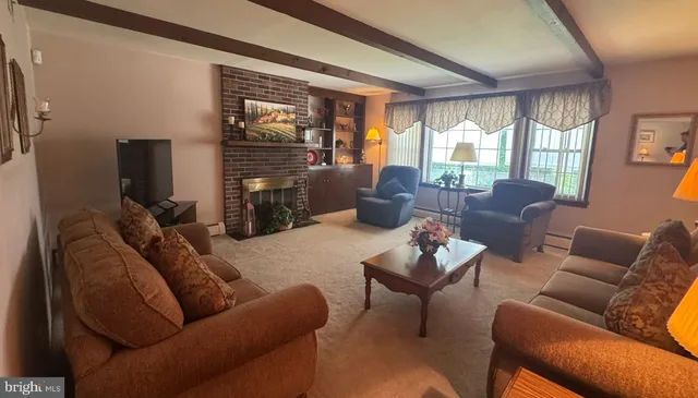 a living room with furniture a large window and a flat screen tv