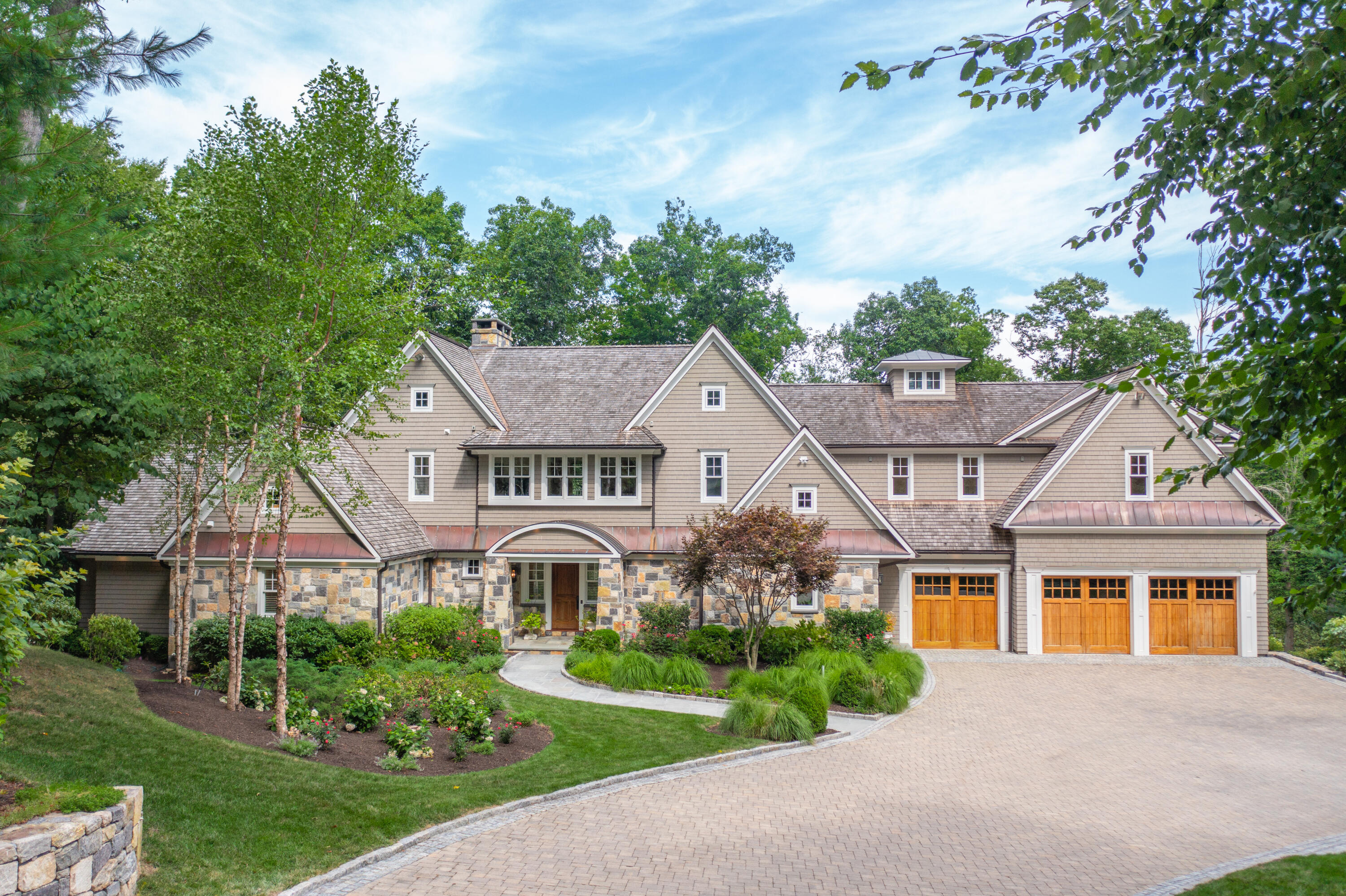 a view of a big house with a big yard and potted plants