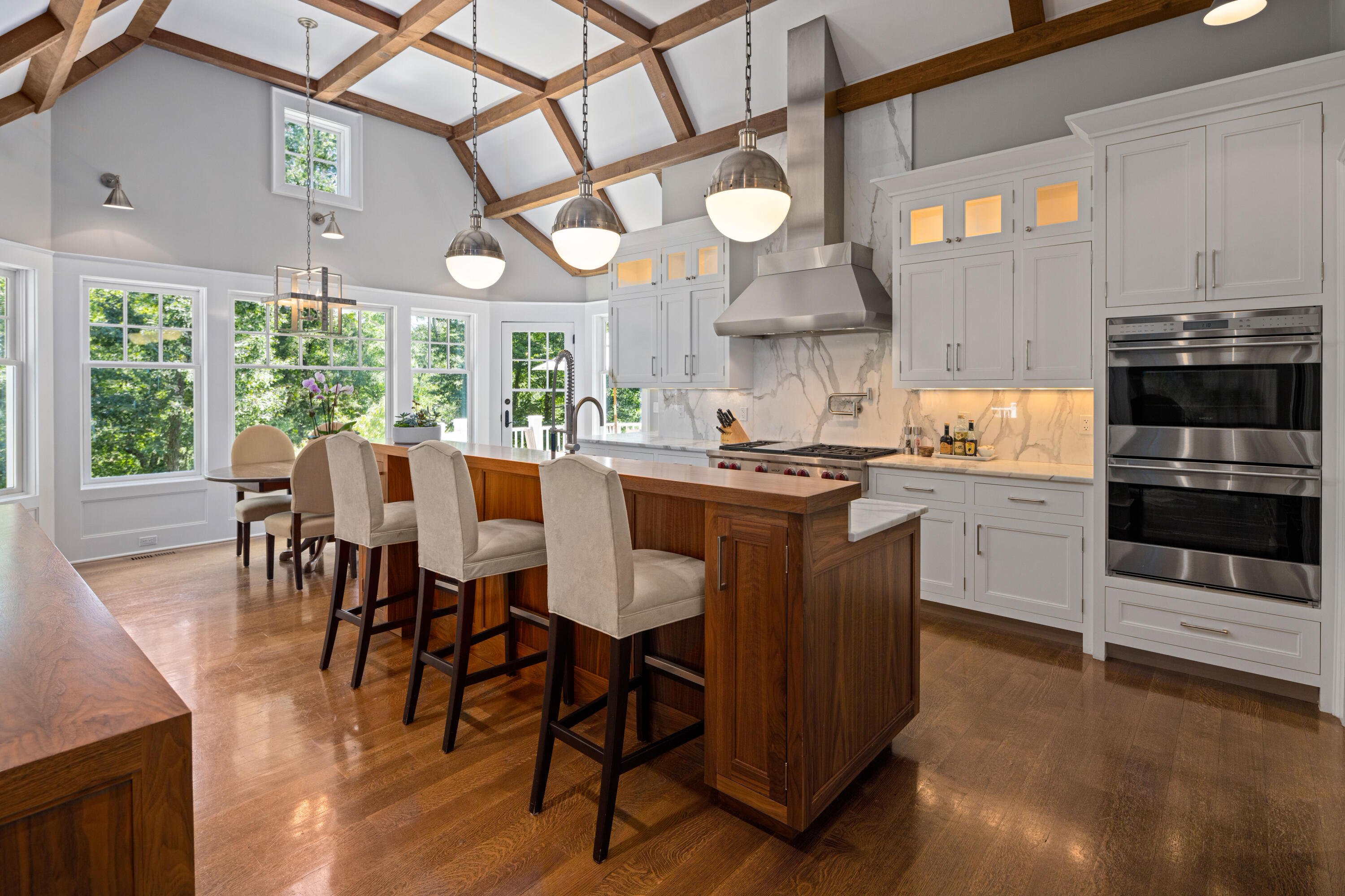 163 Chichester Road New Canaan, CT 06840 - Photo 12 of 40 a kitchen with stainless steel appliances a dining table chairs stove and a refrigerator