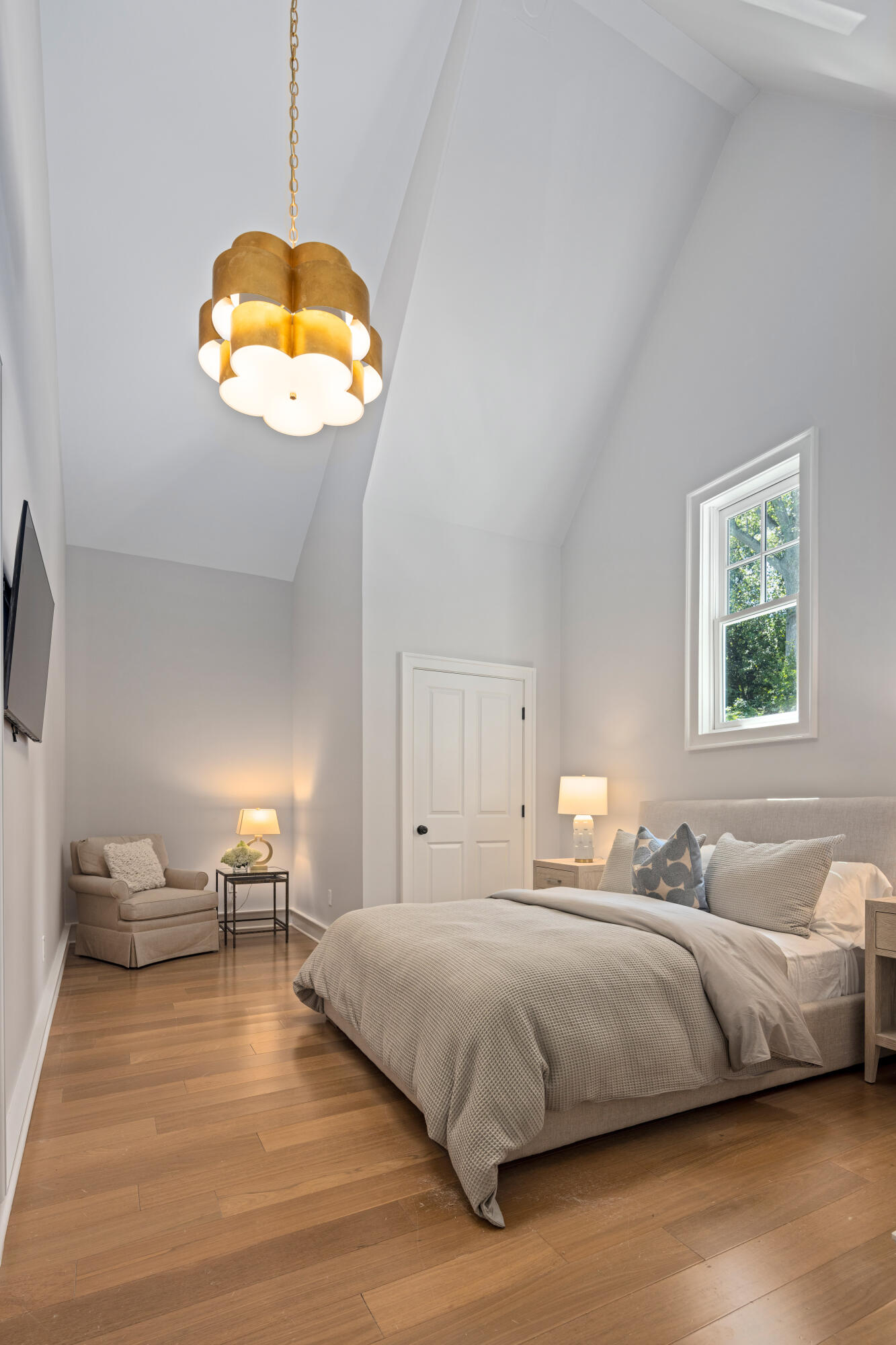 163 Chichester Road New Canaan, CT 06840 - Photo 25 of 40 a bedroom with a bed and a chandelier