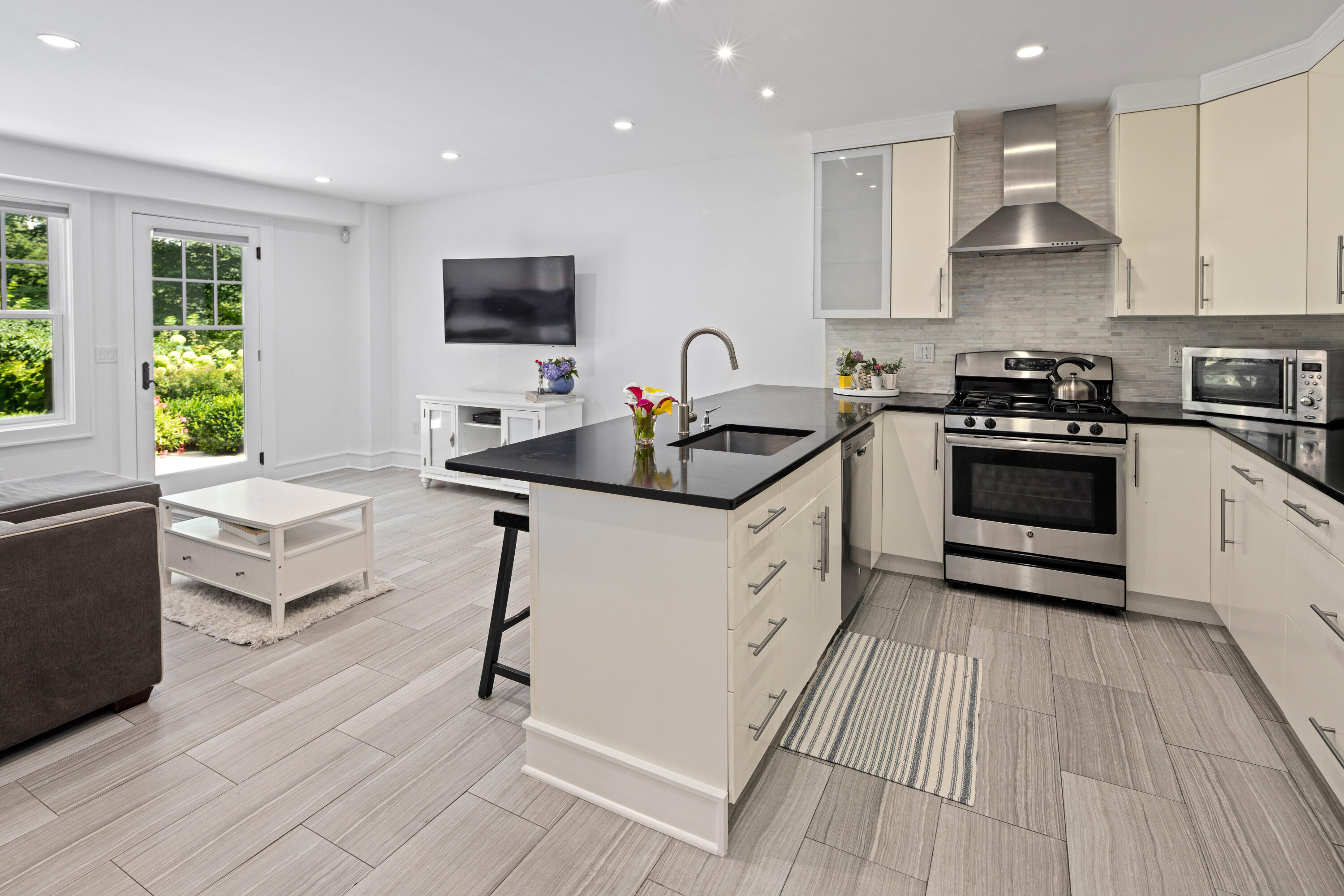 163 Chichester Road New Canaan, CT 06840 - Photo 32 of 40 a kitchen with stainless steel appliances a sink stove and cabinets