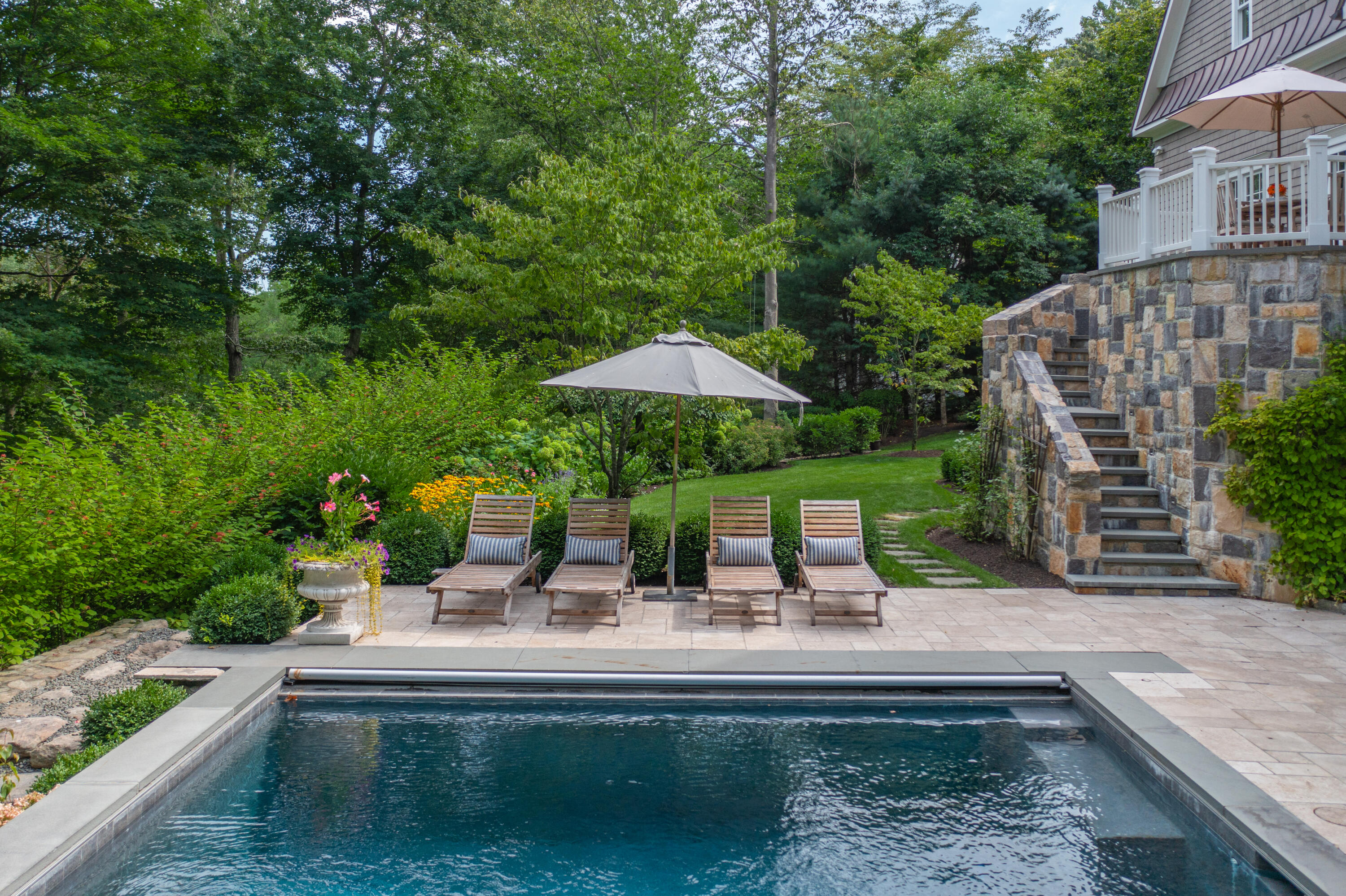 163 Chichester Road New Canaan, CT 06840 - Photo 35 of 40 a swimming pool with outdoor seating and yard