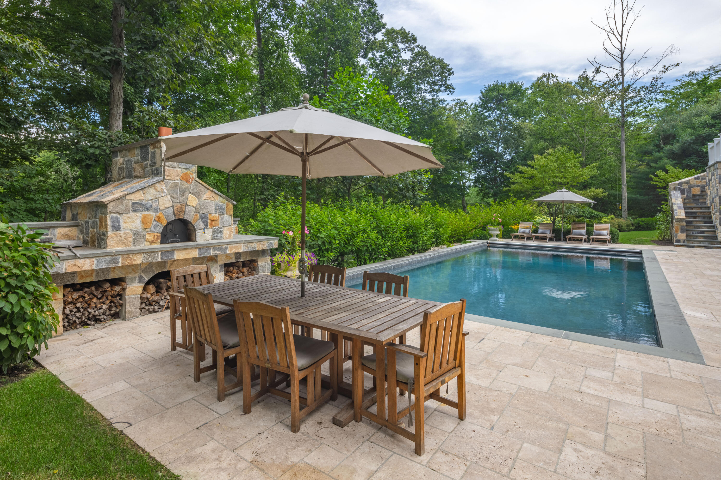 163 Chichester Road New Canaan, CT 06840 - Photo 38 of 40 a view of house with backyard swimming pool and outdoor seating