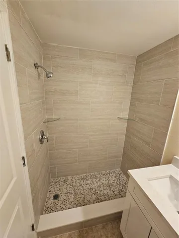 a bathroom with a shower and a sink