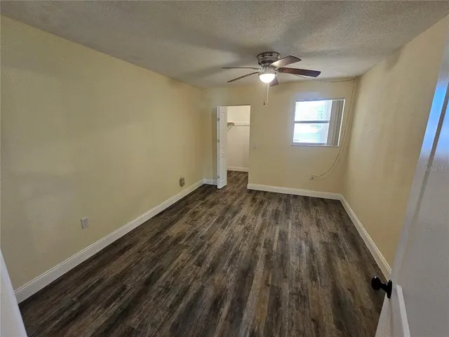 a view of a room with wooden floor and window