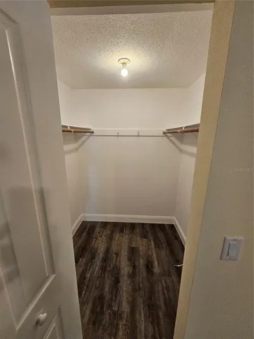 a kitchen with stainless steel appliances a refrigerator a sink and white cabinets