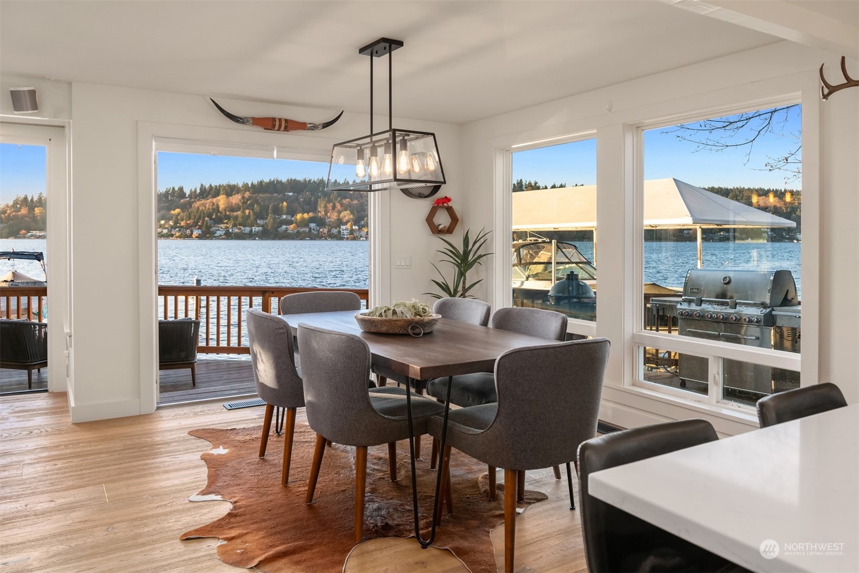 3901 Lake Washington Boulevard North Renton, WA 98056 - Photo 12 of 31 a view of a dining room with furniture wooden floor and chandelier