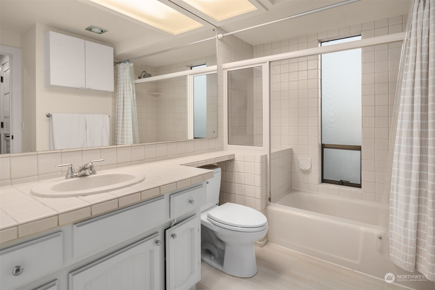 3901 Lake Washington Boulevard North Renton, WA 98056 - Photo 21 of 31 a bathroom with a granite countertop sink toilet and shower