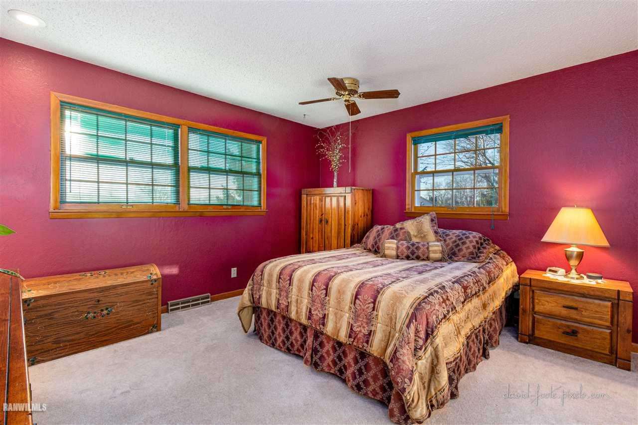 2796 West Hanover Road Hanover, IL 61041 - Photo 10 of 39 a bedroom with a bed and a dresser next to a window