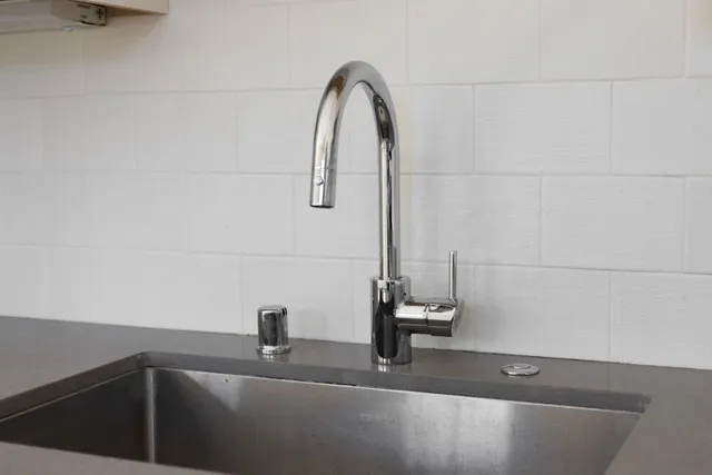 a view of a hallway with wooden floor and a living room