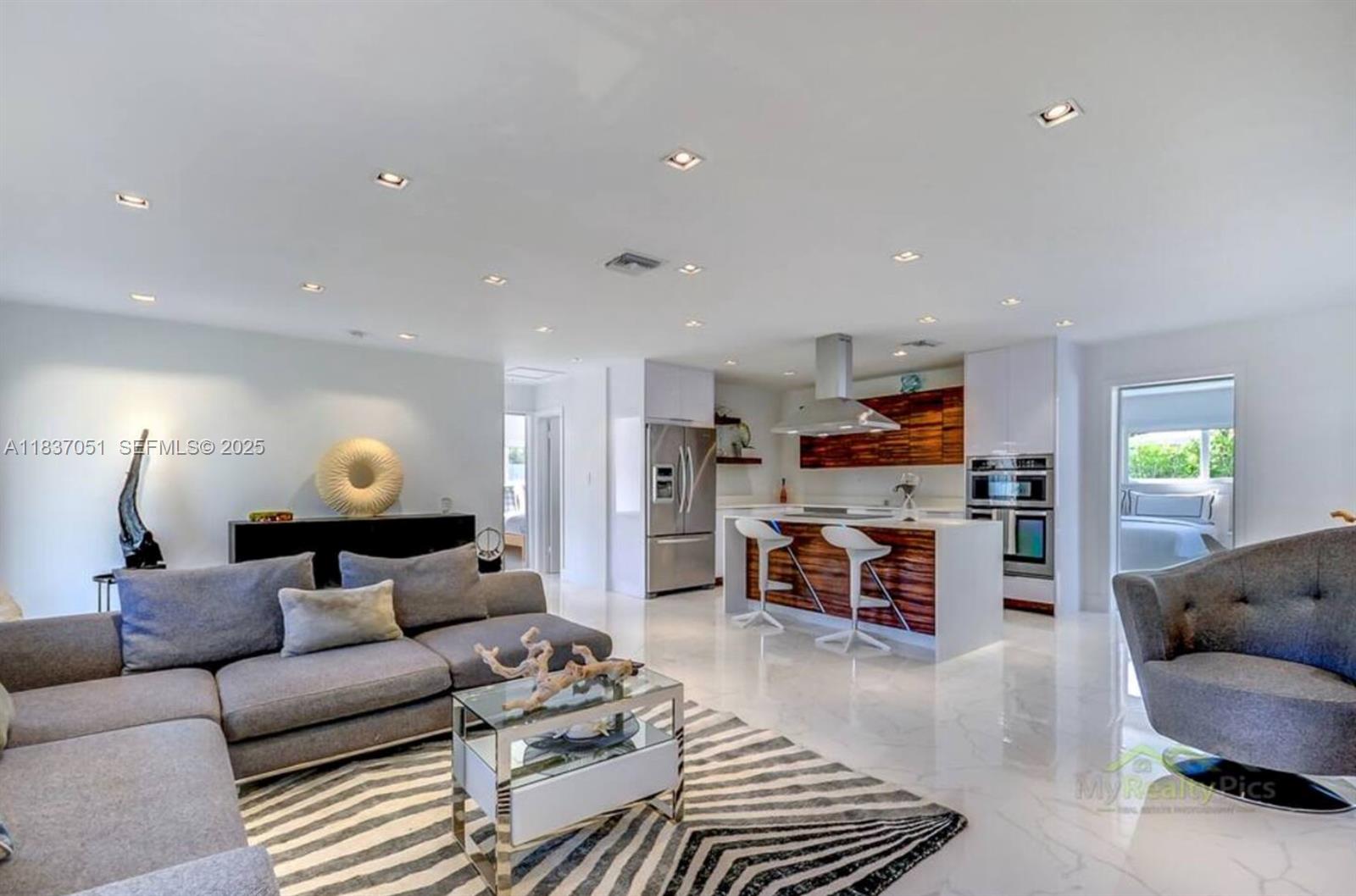 10010 Southwest 162nd Street Miami, FL 33157 - Photo 11 of 22 a living room with furniture and a wooden floor
