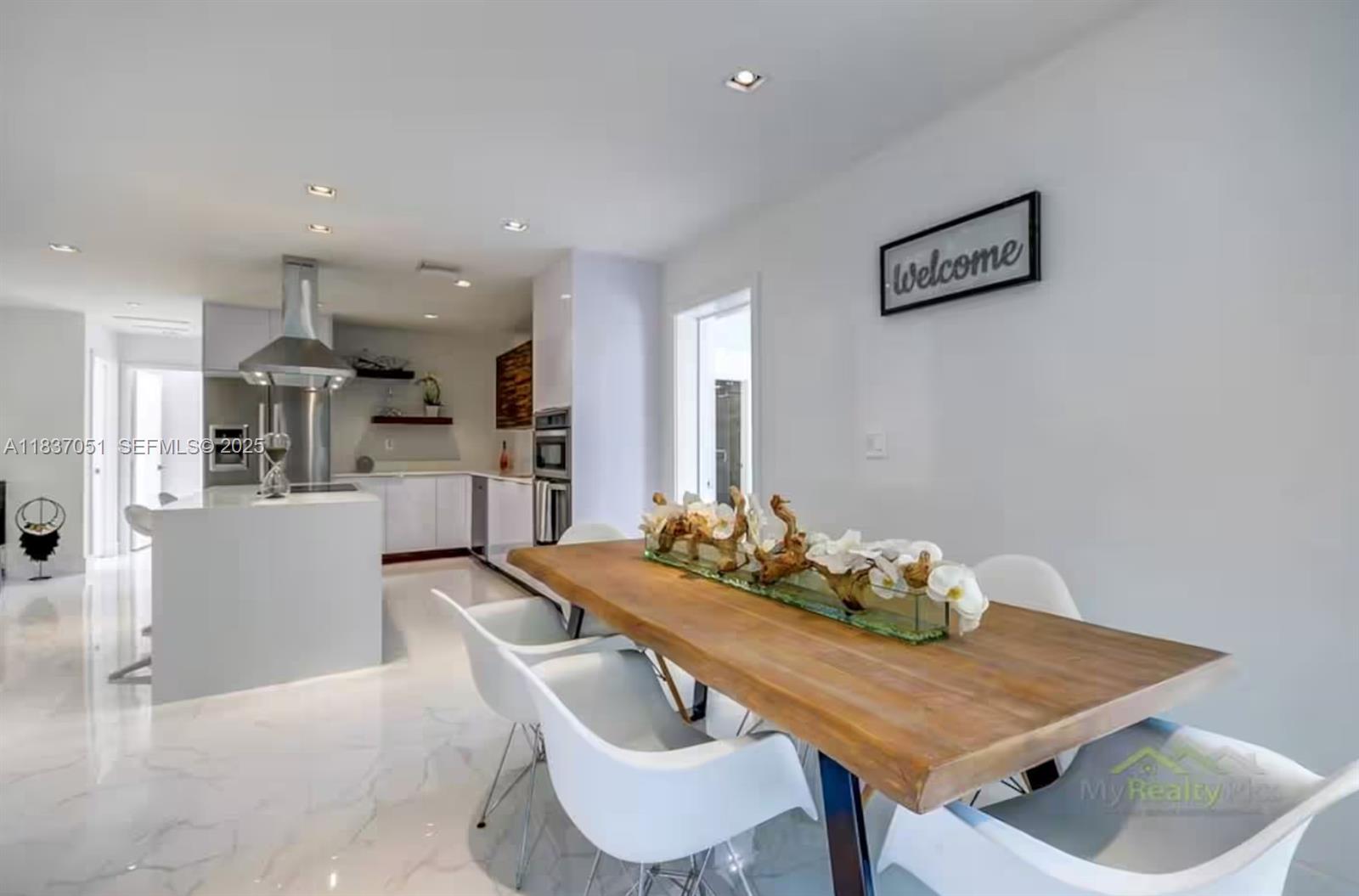 10010 Southwest 162nd Street Miami, FL 33157 - Photo 14 of 22 a dining room with furniture and kitchen view