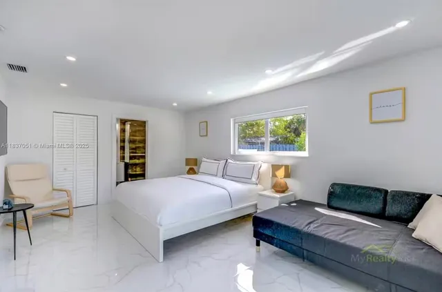 a bedroom with a large bed and a window