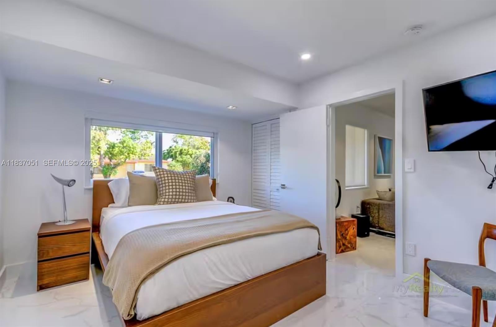 10010 Southwest 162nd Street Miami, FL 33157 - Photo 17 of 22 a bedroom with a large bed and a window