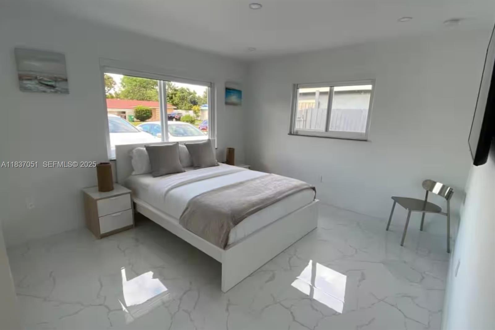 10010 Southwest 162nd Street Miami, FL 33157 - Photo 19 of 22 a bedroom with a bed and a chair