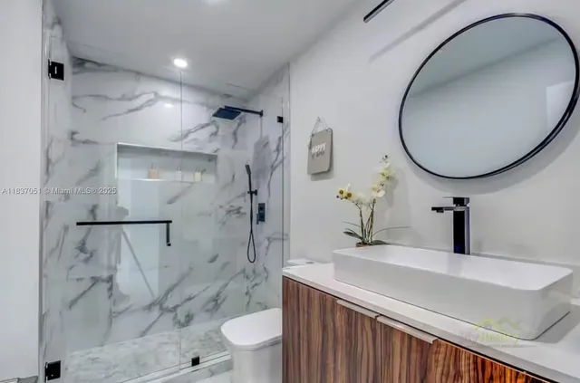 a bathroom with a sink toilet and shower