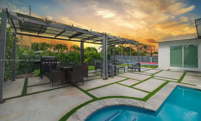 a building outdoor space with patio furniture and potted plants