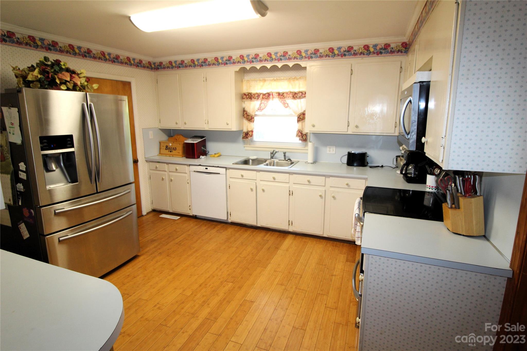 854 Wilmoth Road Clover, SC 29710 - Photo 8 of 33 a kitchen with a sink appliances and cabinets