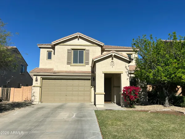 a view of a house with a yard and garage