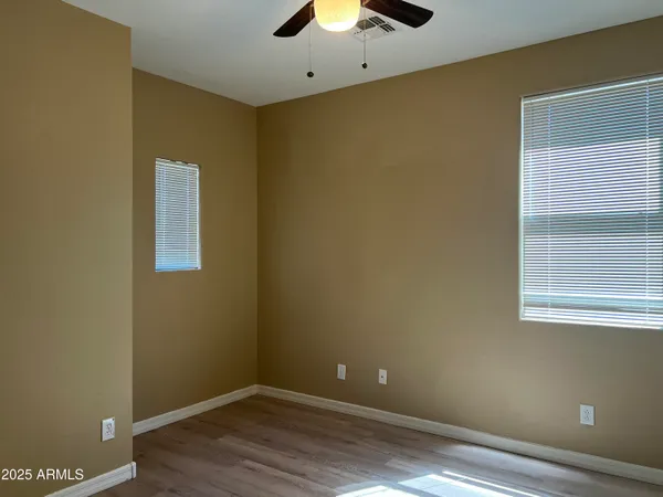 an empty room with wooden floor and a window