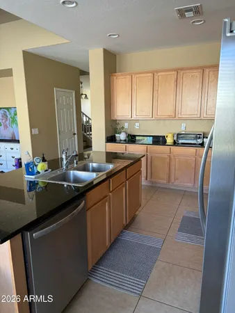 a kitchen with a sink window and cabinets