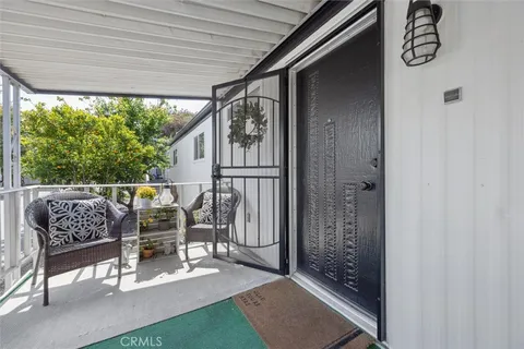 a view of a porch with chairs and backyard