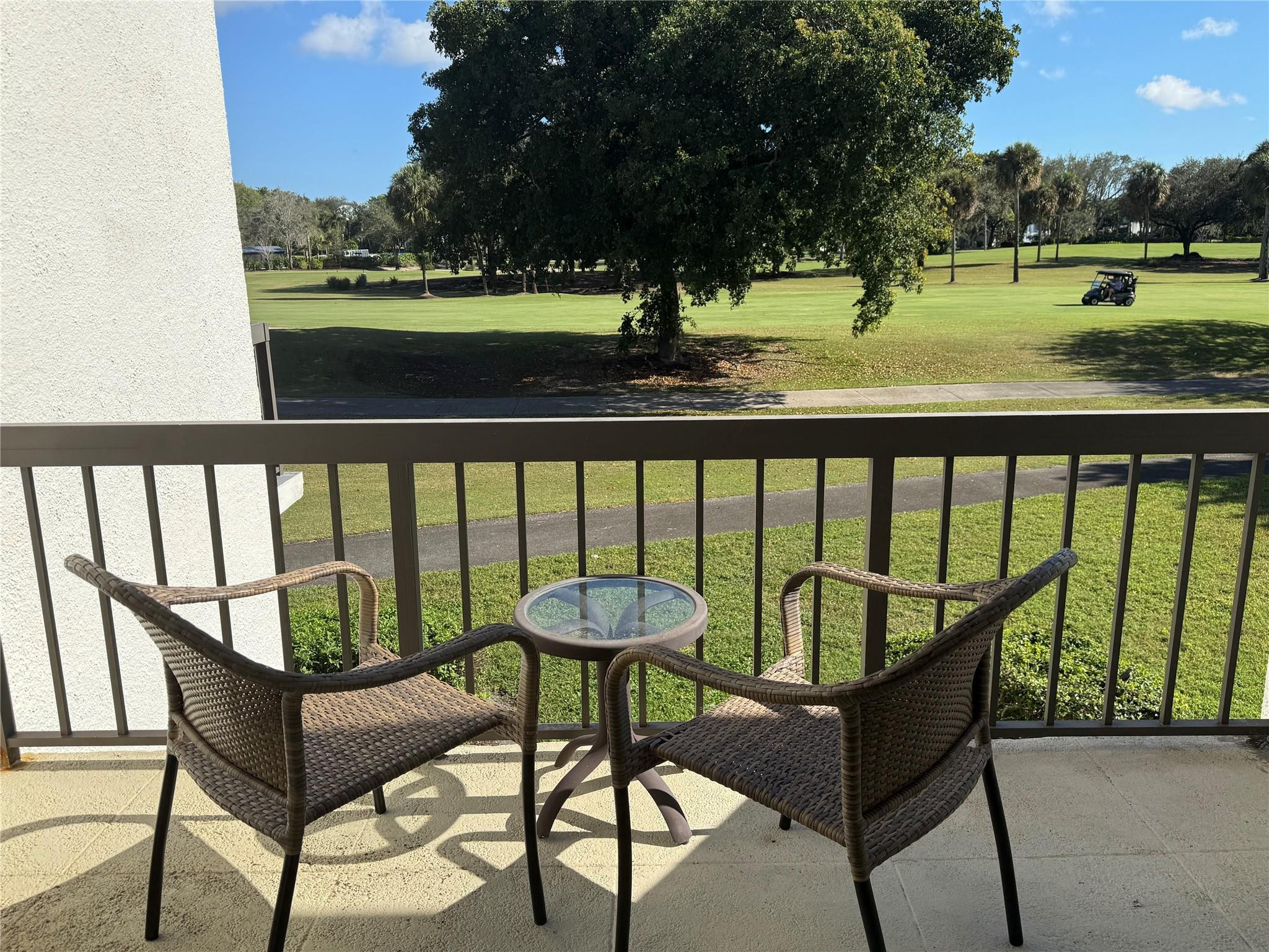 2303 Bridgewood Drive, Unit 2303 Boca Raton, FL 33434 - Photo 14 of 45 a view of a chairs and table on the deck