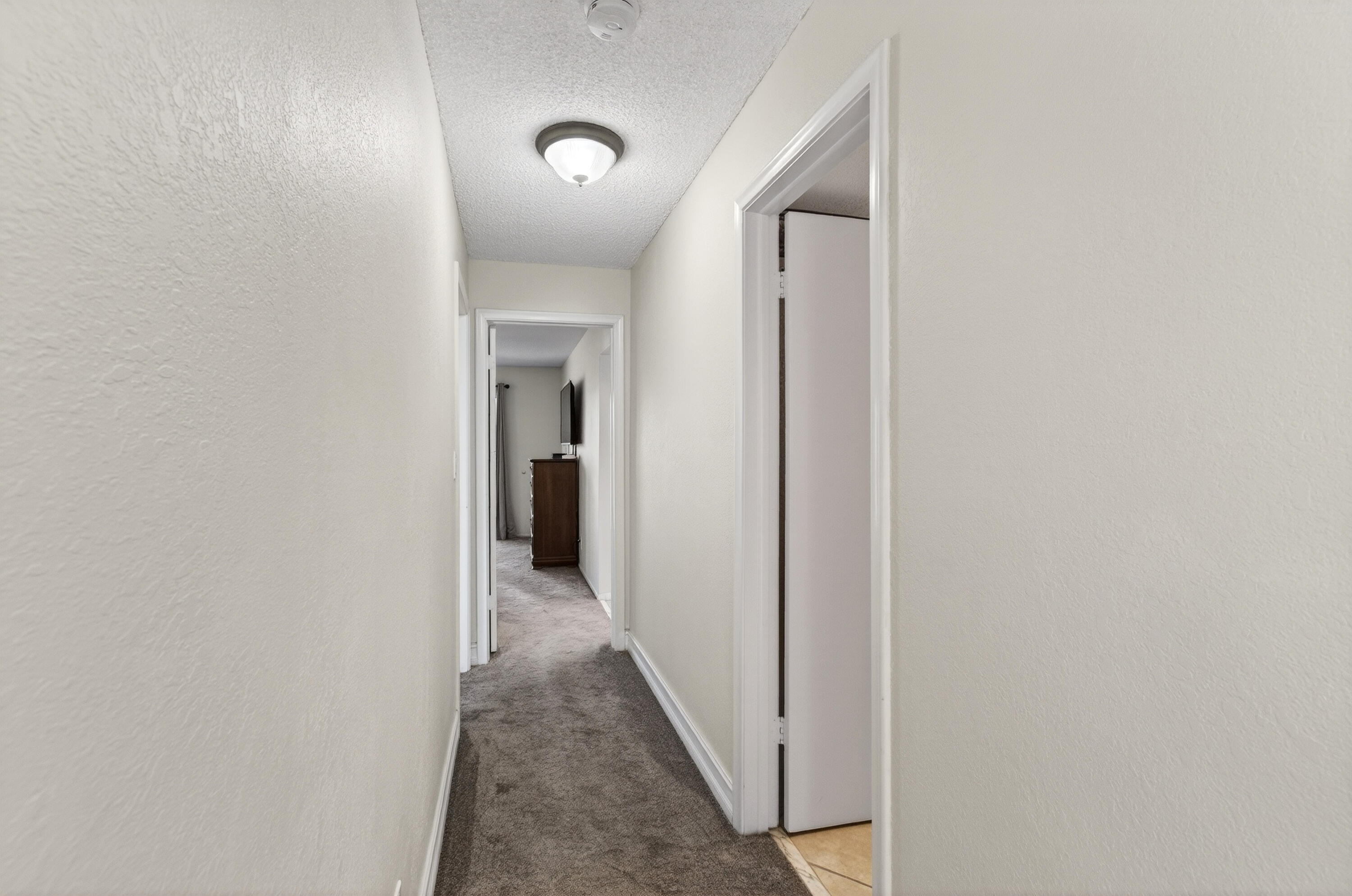 2303 Bridgewood Drive, Unit 2303 Boca Raton, FL 33434 - Photo 26 of 45 a view of a hallway with wooden floor