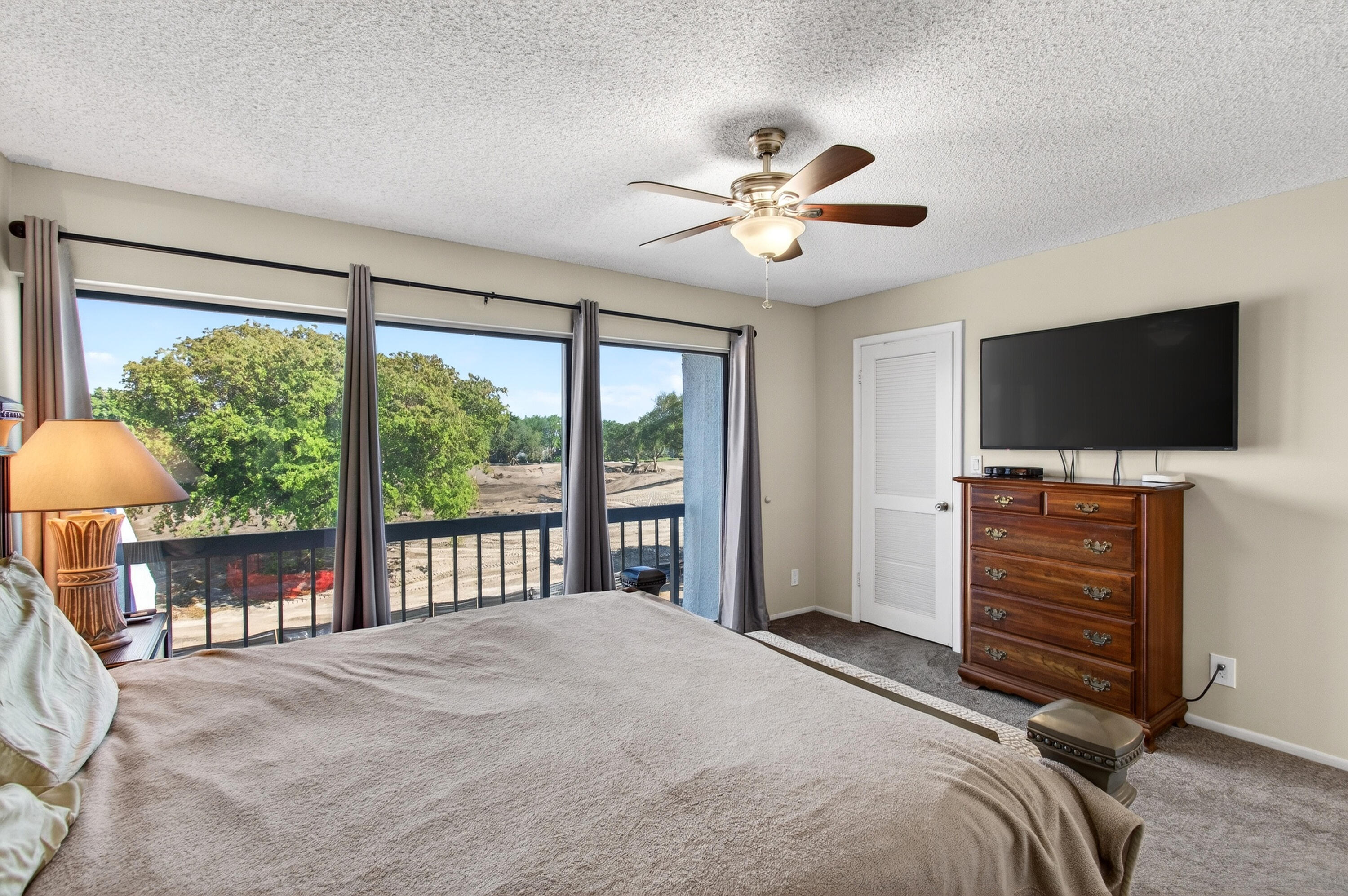 2303 Bridgewood Drive, Unit 2303 Boca Raton, FL 33434 - Photo 28 of 45 a bedroom with a bed and a flat screen tv