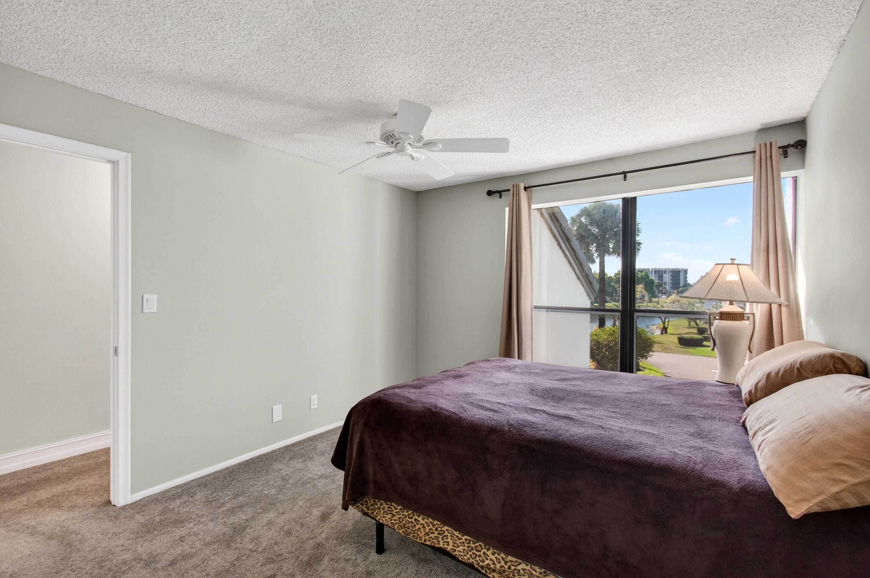 2303 Bridgewood Drive, Unit 2303 Boca Raton, FL 33434 - Photo 35 of 45 a bedroom with a large bed and a window