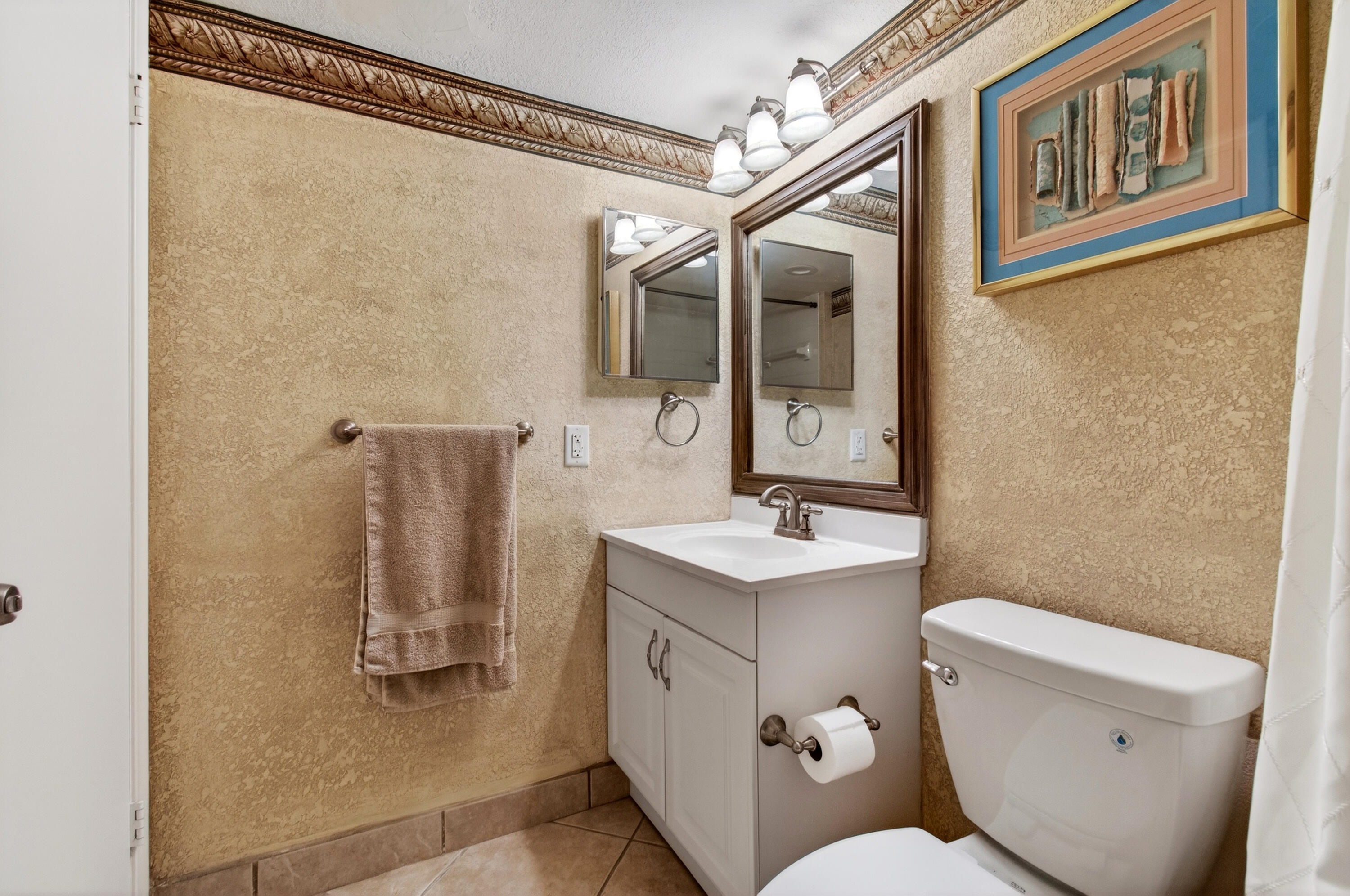2303 Bridgewood Drive, Unit 2303 Boca Raton, FL 33434 - Photo 39 of 45 a bathroom with a sink a toilet a mirror and shower