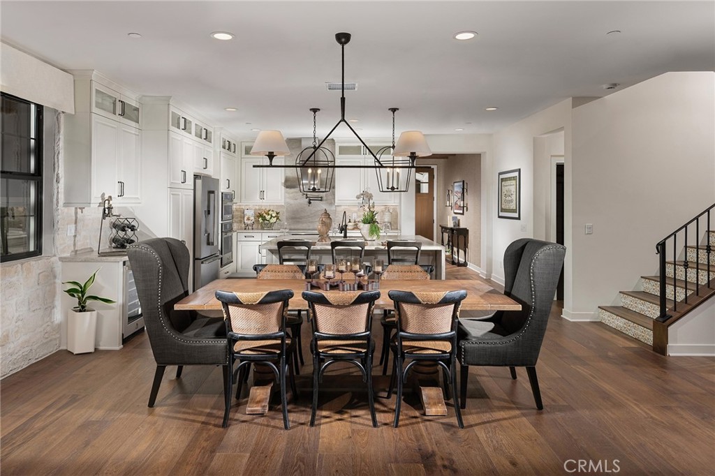 2975 Place De Mouton Bonsall, CA 92084 - Photo 9 of 13 a dining room with furniture a chandelier and wooden floor