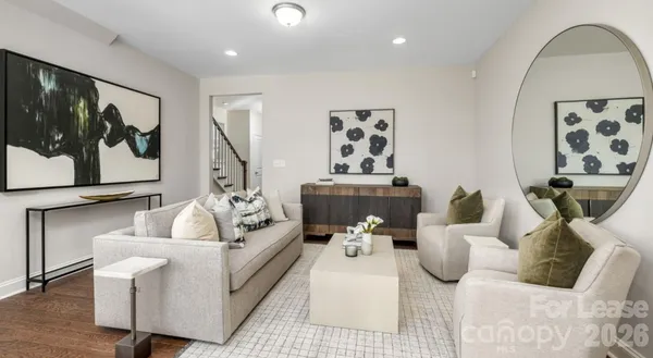 a living room with furniture and a painting