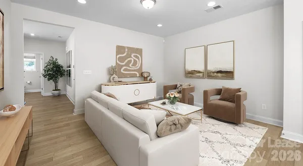 a living room with furniture and wooden floor