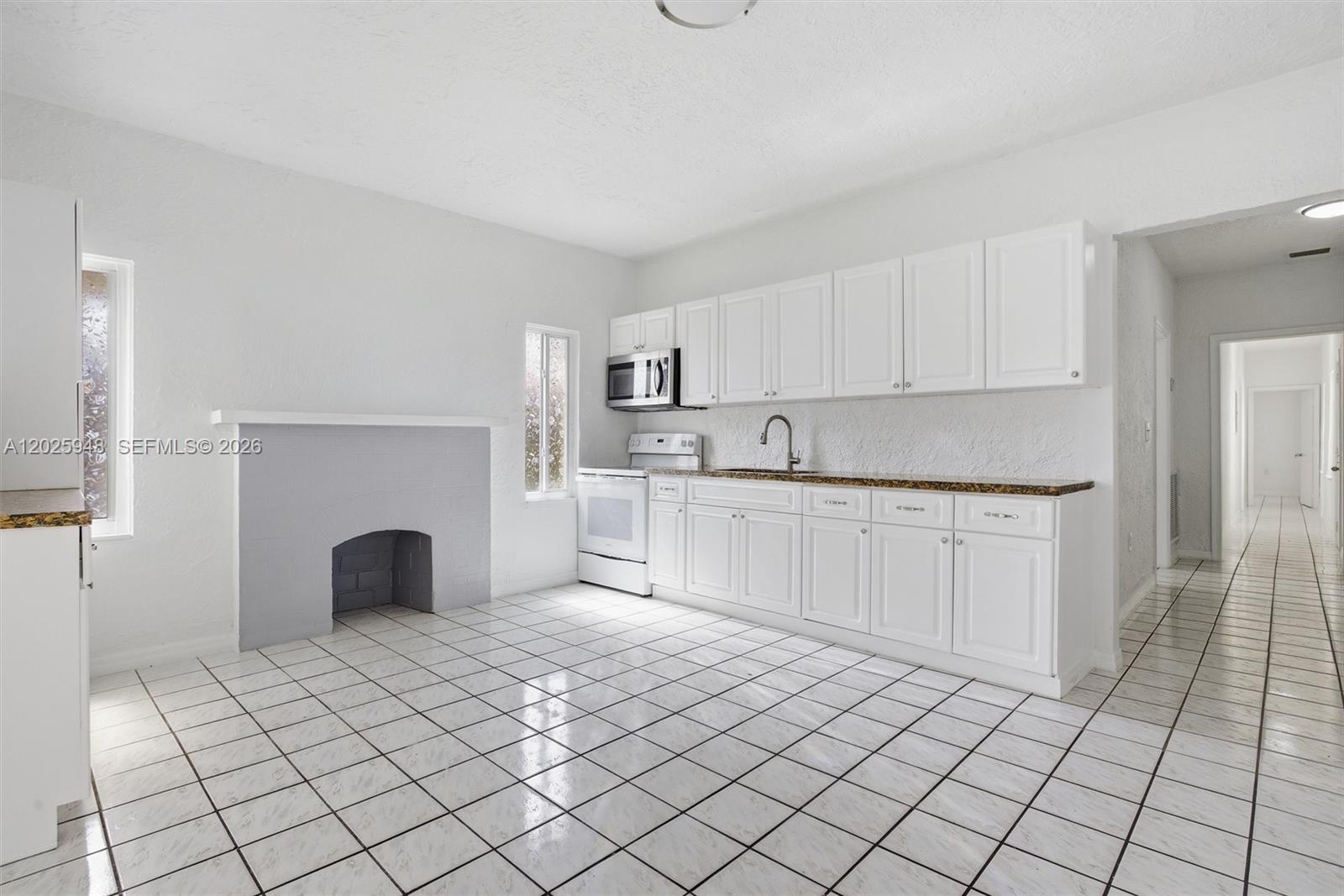 1745 Southwest 17th Street, Unit 2 Miami, FL 33145 - Photo 7 of 32 a view of kitchen with granite countertop cabinets and window