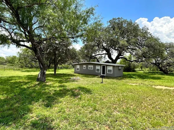 a front view of a house with yard and green space
