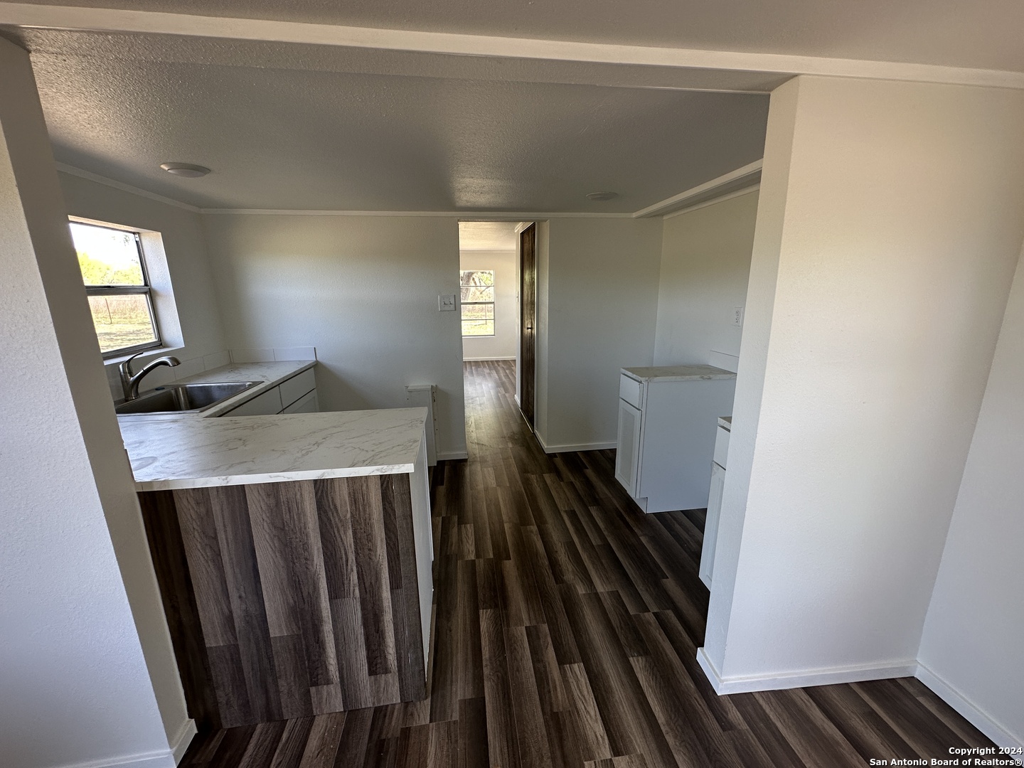 5515 Farm To Market 462 Devine, TX 78016 - Photo 12 of 27 a view of a hallway with wooden floor and staircase