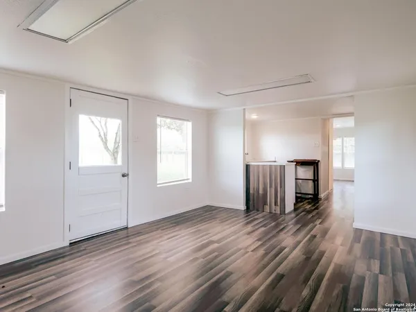 wooden floor in an empty room with a window