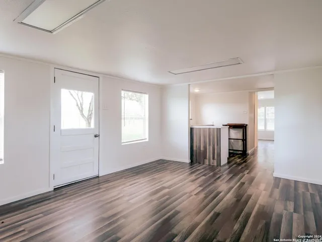 wooden floor in an empty room with a window
