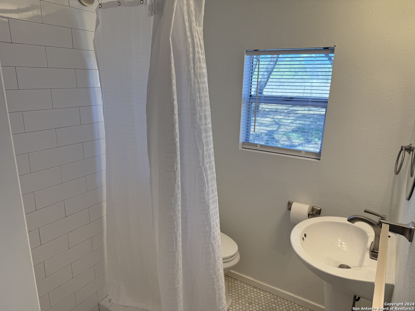5515 Farm To Market 462 Devine, TX 78016 - Photo 22 of 27 a bathroom with a toilet a sink and mirror