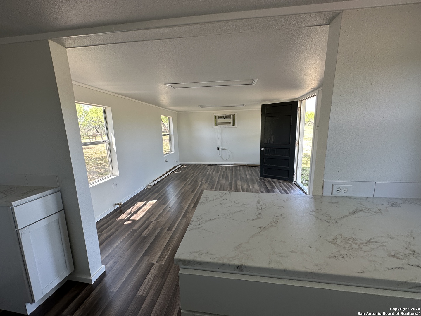 5515 Farm To Market 462 Devine, TX 78016 - Photo 6 of 27 a view of an empty room and wooden floor