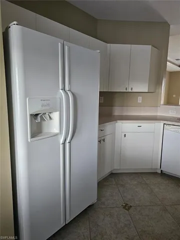 a utility room with cabinets washer and dryer