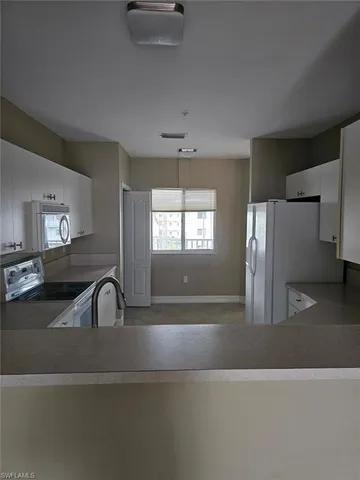 a kitchen with a refrigerator and a sink