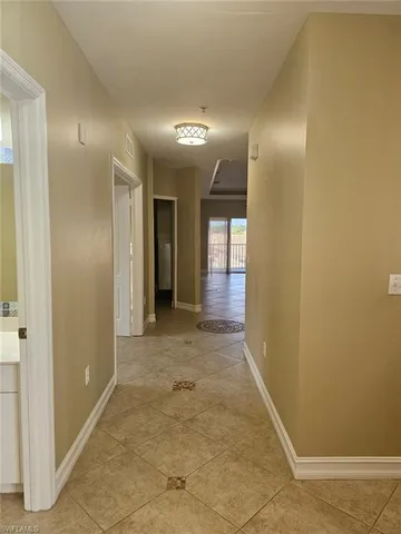 a view of hallway with bathroom