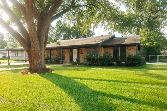 a view of a house with a yard patio and a swimming pool
