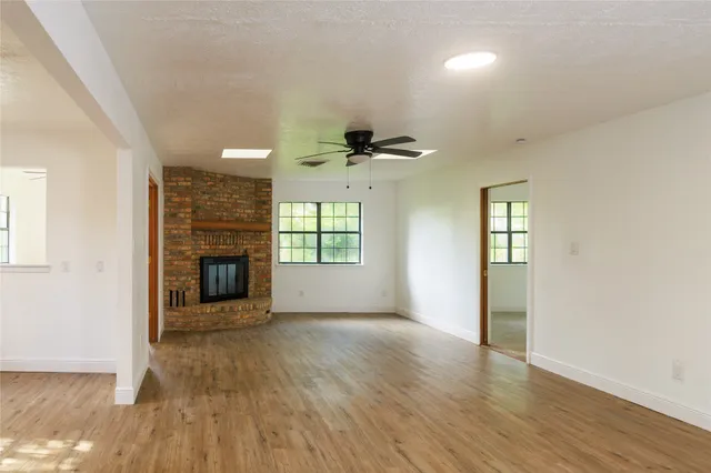 an empty room with closet and a chandelier fan