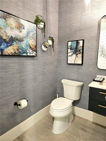 a white toilet sitting next to a bathroom sink