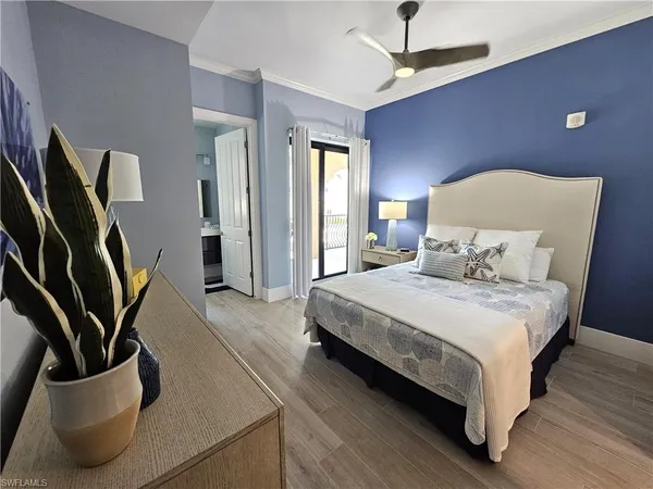 a bedroom with furniture and a flat screen tv